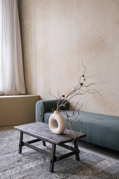 istock Geometric ceramic vase with branches on wooden table 1406593629