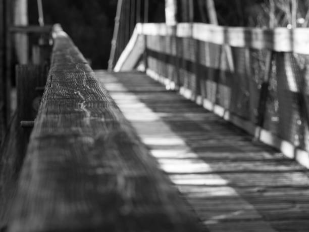 istock Wooden suspension bridge black and white 1406594862