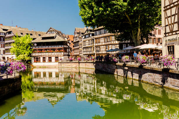 Alsace. Old ancient French city Strasbourg. Summer trip to France. European country. French architecture. Voyage. Warm sunny day. Travel destination. Street. Facade of houses. Il river stock photo