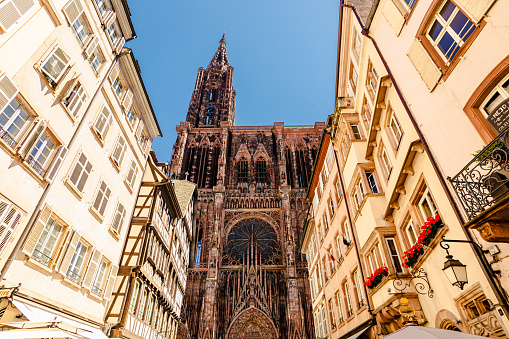 Strasbourg Cathedral. Alsace. Old ancient French city Strasbourg. Summer trip to France. European country. French architecture. Voyage. Warm sunny day. Travel destination. Street. Facade of houses