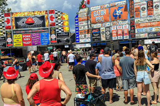 Penticton, British Columbia, Canada - June 30, 2022: Crowds of people at the Penticton Rib Fest where barbecue teams from across Canada compete for best ribs. You’ll also find live music, entertainment, and activities.
