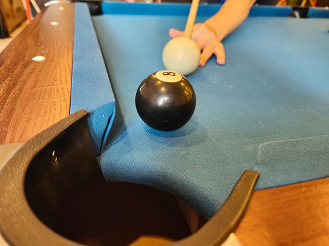 A focus scene on human hand ready for pool game.