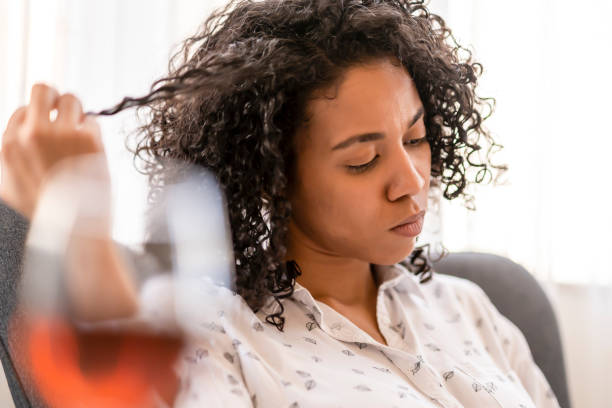istock Woman is twirling her hair while reading 1406605317