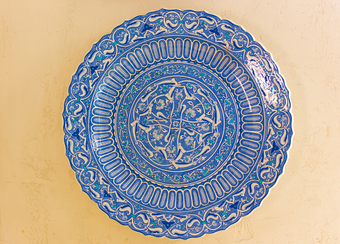 Antique Blue Turkish Plate Hanging on Yellow Wall