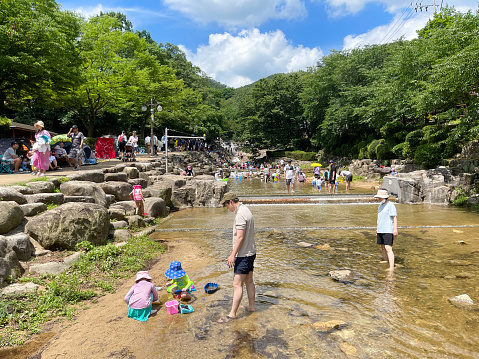 Gwacheon, Korea - July 2nd 2022, Families enjoying the water stream on the valley of Gwanaksan Gwacheon Korea.