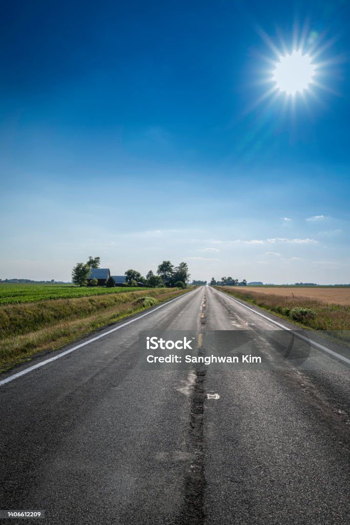 Heartland of America landscape of the rural road in Ohio, USA Heartland of America landscape of the corn field along the rural road in Ohio, USA Empty Road Stock Photo