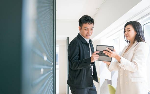 istock Business office staff talking while looking at digital tablet. 1406613120