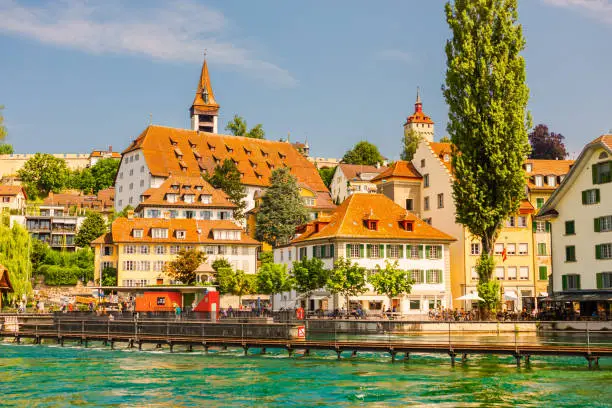 Old ancient Swiss city Lucerne. Beautiful landscape. Background. Summer trip to Switzerland. European country. Voyage. Warm sunny day. Travel destination. Royce river