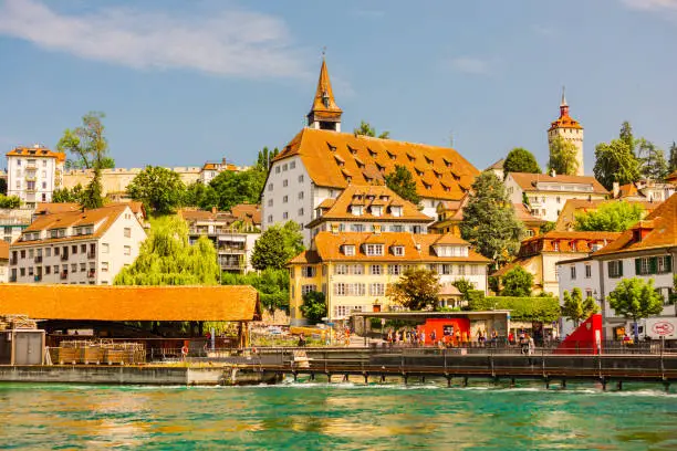 Old ancient Swiss city Lucerne. Beautiful landscape. Background. Summer trip to Switzerland. European country. Voyage. Warm sunny day. Travel destination. Royce river