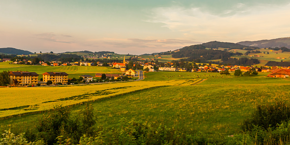 Arable field in Switzerland. Cultivate the land. Sustainable development.  Background. Summer trip to Switzerland. European country. Voyage. Warm sunny day. Travel destination. Copy space. Sunset