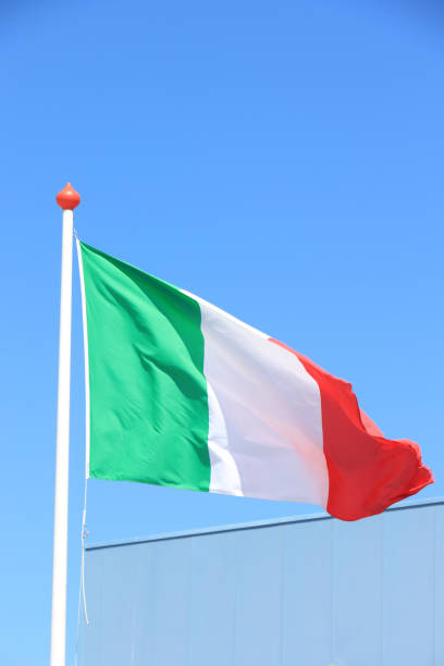 Italian flag and blue sky stock photo
