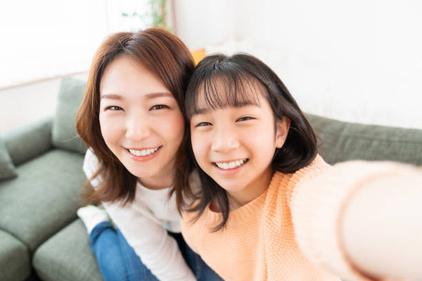asian mother and daughter,smart phone,Selfie