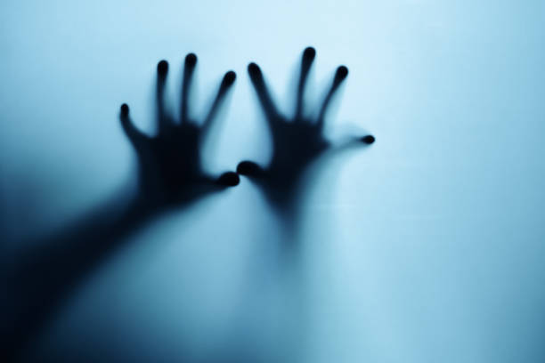 istock Shadow of a zombie hand on white background 1406621476