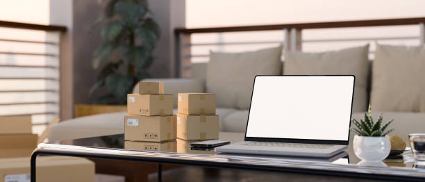 istock Modern home living room interior design with portable notebook, parcel boxes on coffee table. 1406627825