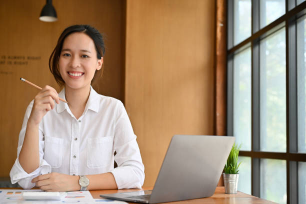 istock Attractive and cheerful female financial worker with laptop 1406629062