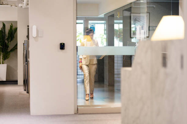 Asian business woman ready for work to office. Asian business woman with bag, reusable cup, and work permit getting into the office for work. walking into glass door stock pictures, royalty-free photos & images