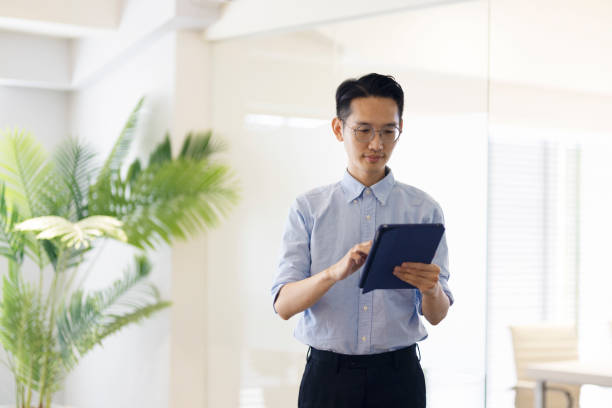istock Asian businessman looking at the camera and smile. 1406630883