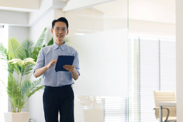 istock Asian businessman looking at the camera and smile. 1406630890