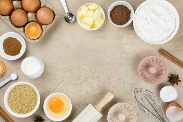 istock Frame of ingredients for baking. Ingredients for making dough, cakes, muffins, cookies. Baking ingredients: flour, sugar, eggs, spices, milk, chocolate, baking powder, whisk, rolling pin, muffin tins. 1406631272