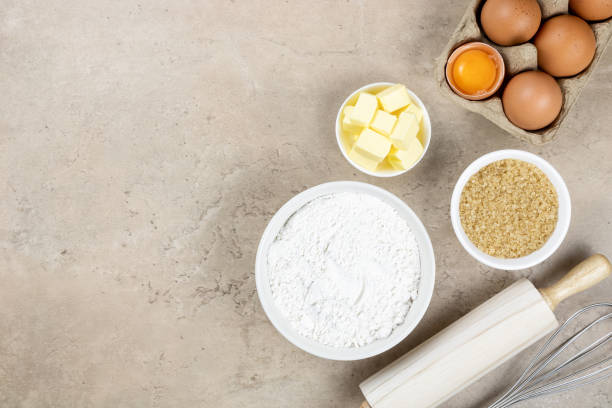 istock Utensils and ingredients for making cakes, cookies, cupcakes. Baking ingredients - flour, sugar, butter, eggs, rolling pin, whisk. Top view, copy space. 1406631289