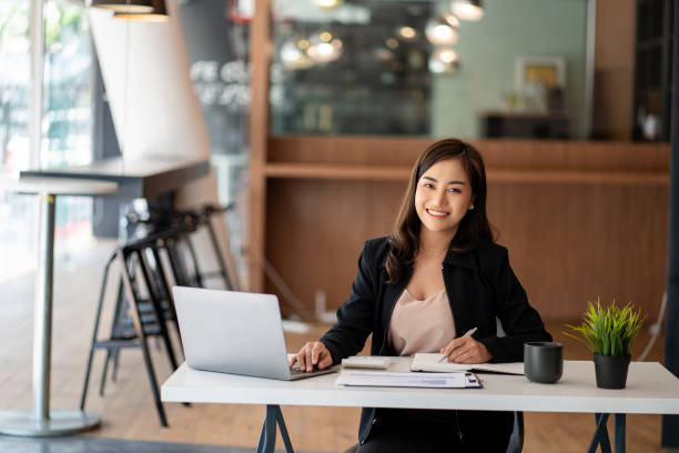 istock Asian businesswoman working using laptop computer in modern office Make an account analysis report with financial graphs and real estate investment data. financial and tax system concepts 1406632143