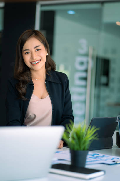 istock Asian businesswoman working using laptop computer in modern office Make an account analysis report with financial graphs and real estate investment data. financial and tax system concepts 1406632179