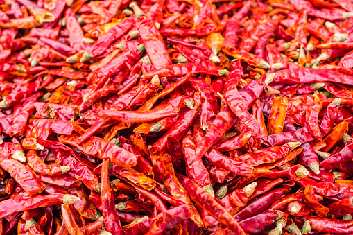 Red hot chili pepper and mix of pepper on a white wooden background. Flatlay, top view