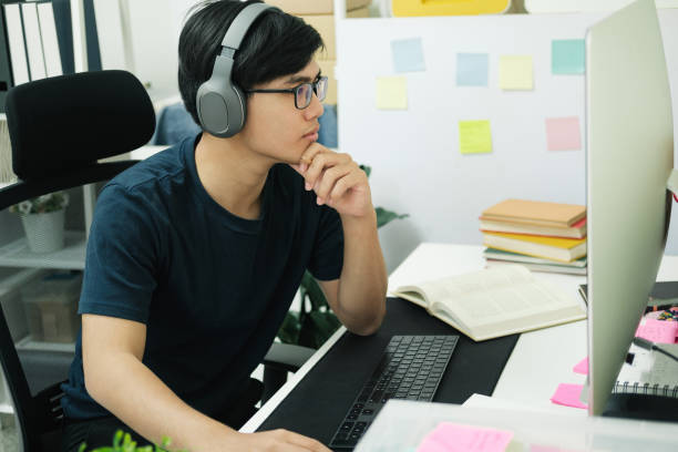 istock Young man study in front of the laptop computer at home. 1406634257