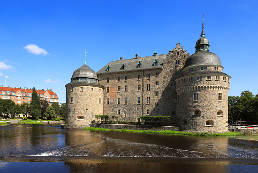 view on historic Marburg over Lahn river at blue summer morning with weir in the foreground and castle in the background