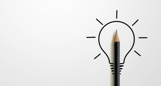 istock Black colour pencil with outline light bulb and word idea on white paper background. Creativity inspiration ideas concept 1406635346