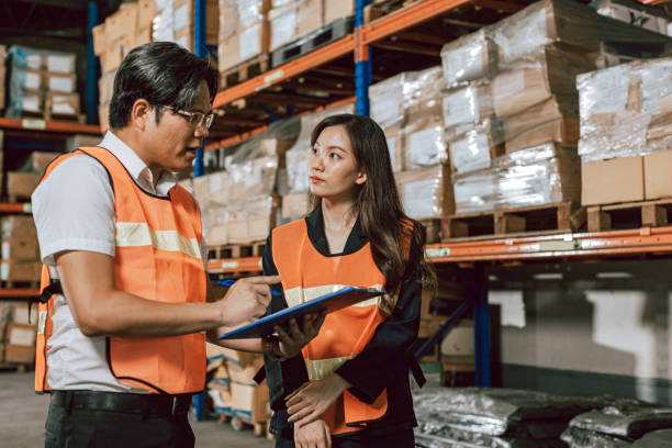 istock Warehouse supervisor talking to manager in warehouse. 1406635869