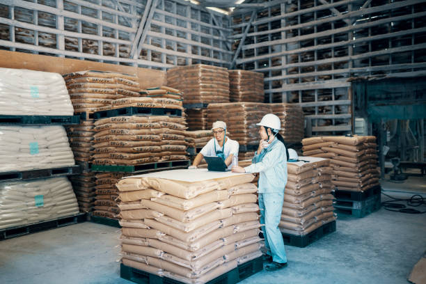 istock Mid adult colleagues talking in a warehouse 1406636215