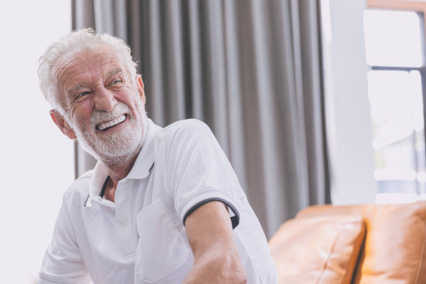 happy elderly man healthy senior confident smile with beautiful white teeth from denture prosthetics. stock photo