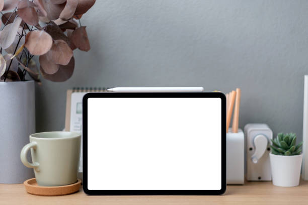 istock Blank screen tablet on working desk decor with stationery at home 1406639211