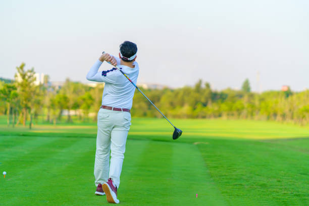 istock Man Golfer Hitting Ball with Club on Beatuiful Golf Course 1406641764