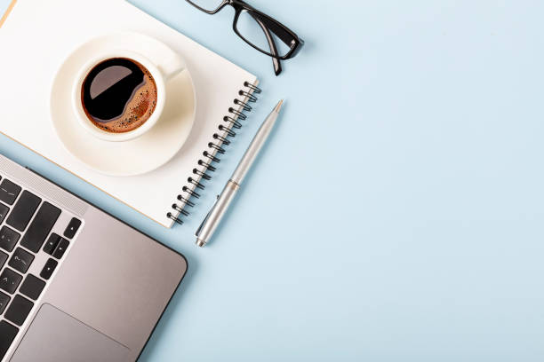 istock Business desk workplace and office objects over blue backdrop. Top view flat lay with copy space for your text 1406646692