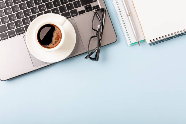 istock Business desk workplace and office objects over blue backdrop. Top view flat lay with copy space for your text 1406646826
