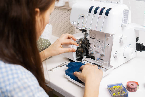 istock Girl threading the needle of a sewing machine. 1406647965