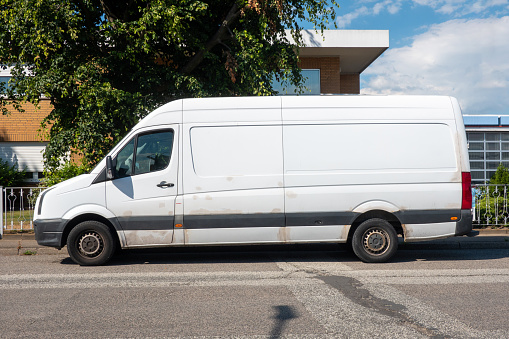 White delivery van parked on the street in the commercial area
