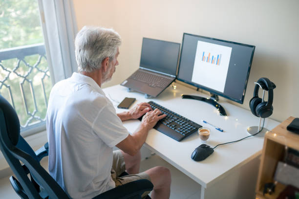 istock Senior man working from home on a remote job in a home office 1406652659