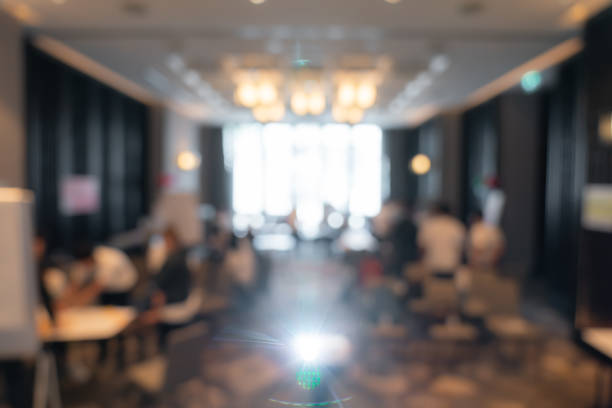 istock Blurry workshop atmosphere, with a projector in front of the hotel room, is suitable for use as a background image in a presentation. 1406653744