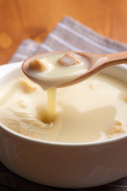 Drink warm corn soup with a wooden spoon.