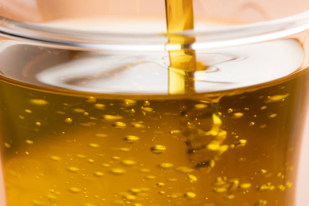 istock Close-up of olive oil flowing down 1406655222