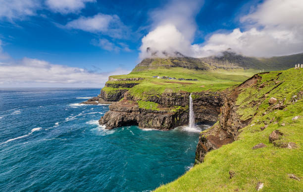 istock Gasadalur with Mulafossur waterfall on Vagar, Faroe Islands 1406655318