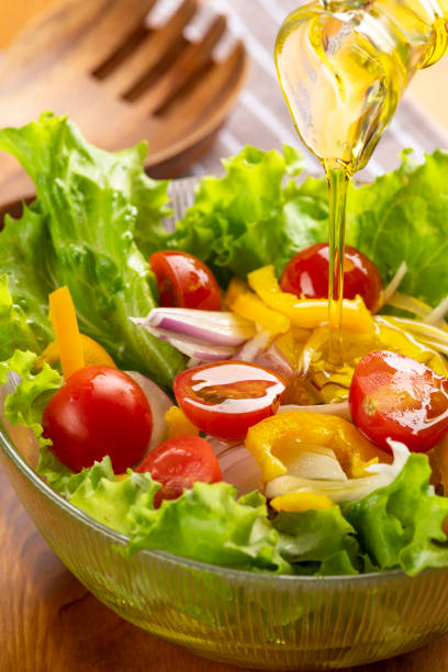 istock Eat tomato and lettuce salad with olive oil. 1406655340