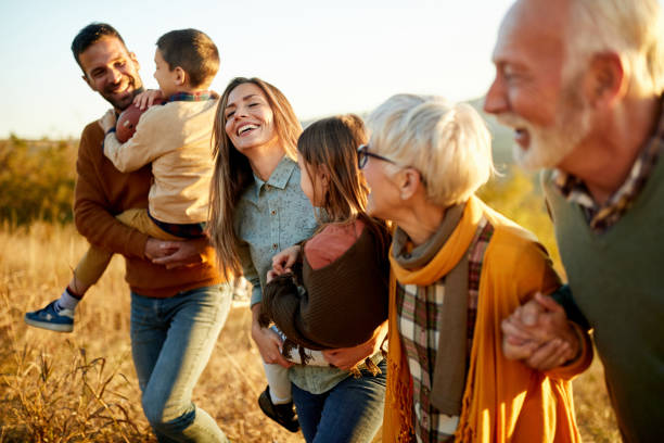 istock Happy multi-generation family talking while taking a walk on the field. 1406656459