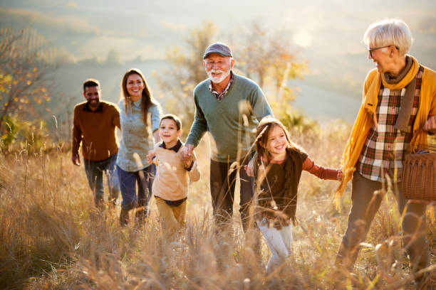 istock Happy multi-generation family going on a picnic in autumn day. 1406656685