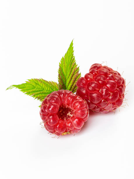 istock Ripe raspberries with leaf isolated on a white background 1406656986