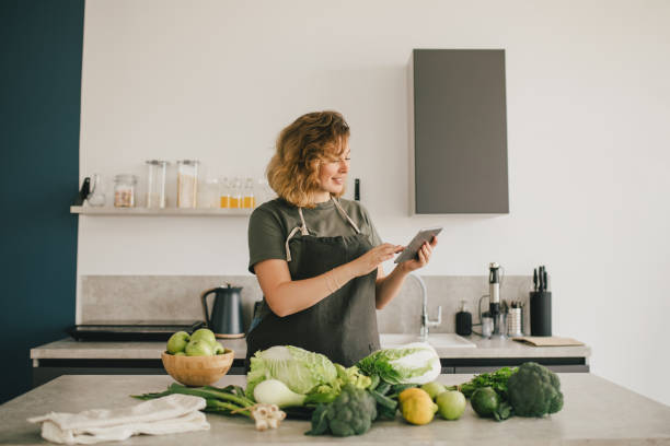 istock Still life with green fruit and vegetables on grey table in the kitchen interior. 1406657048
