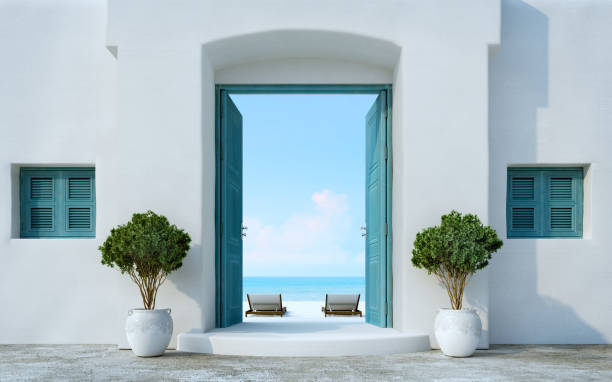 puerta de estilo santorini abierta a la playa y vistas al mar.3d representación - santorini greece villa beach fotografías e imágenes de stock